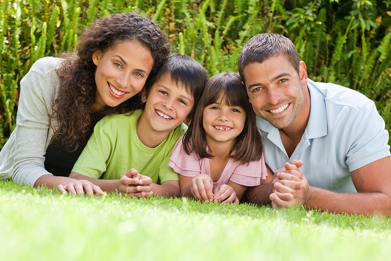 parents and two kids on grass